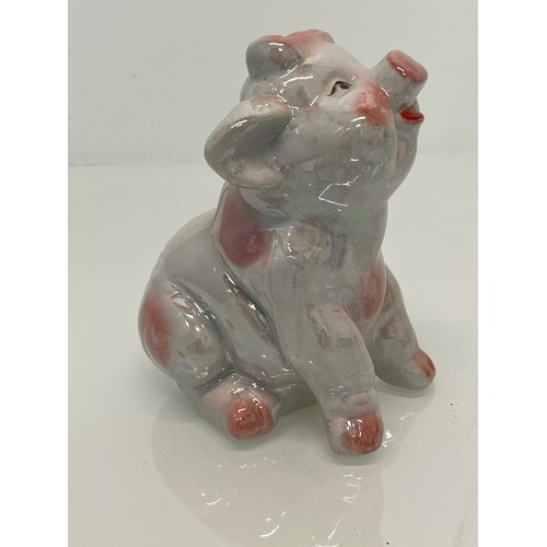 222 - A lustre glazed money box in the form of a seated pig.


This lot is available for in-house shipping