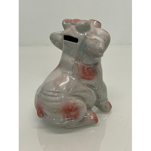 222 - A lustre glazed money box in the form of a seated pig.


This lot is available for in-house shipping