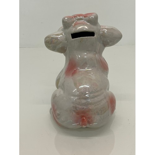 222 - A lustre glazed money box in the form of a seated pig.


This lot is available for in-house shipping