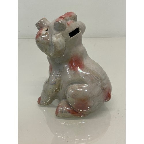 222 - A lustre glazed money box in the form of a seated pig.


This lot is available for in-house shipping