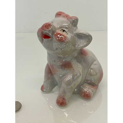 222 - A lustre glazed money box in the form of a seated pig.


This lot is available for in-house shipping