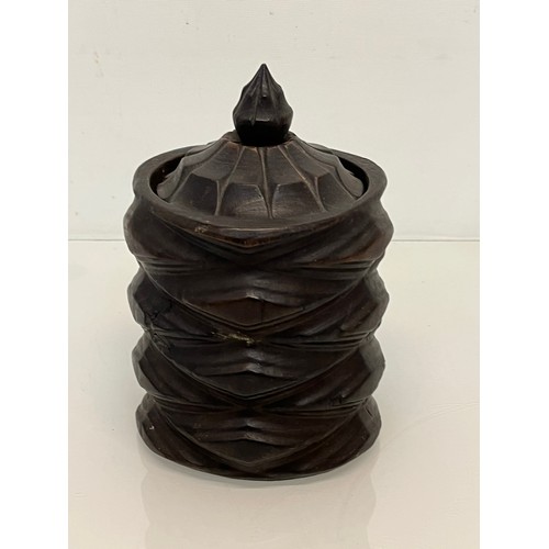 223 - A lidded treen pot with organic carving to the body, 19cm high.

This lot is available for in-house ... 