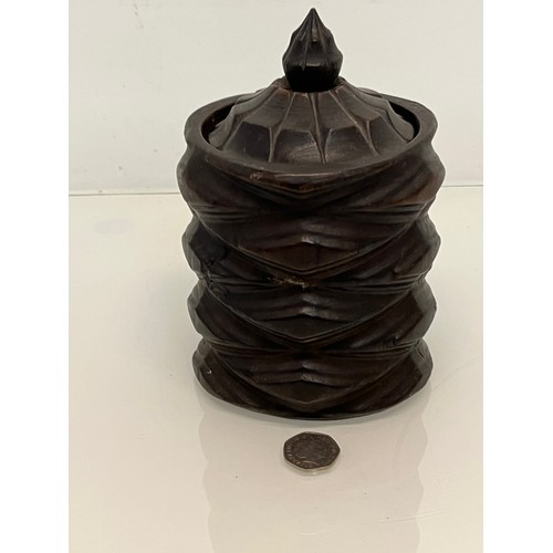 223 - A lidded treen pot with organic carving to the body, 19cm high.

This lot is available for in-house ... 