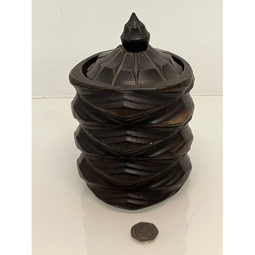 223 - A lidded treen pot with organic carving to the body, 19cm high.

This lot is available for in-house ... 