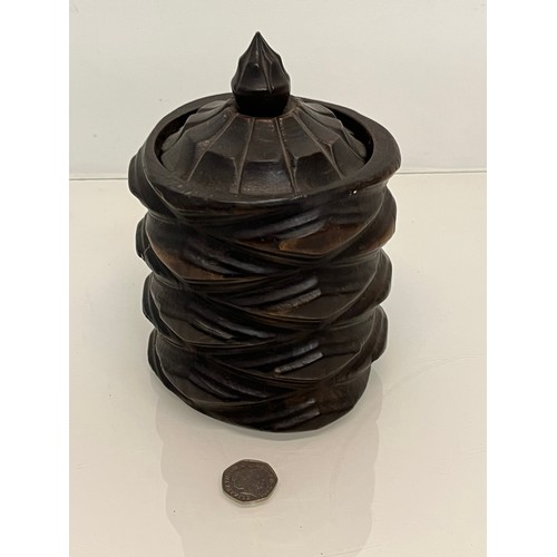 223 - A lidded treen pot with organic carving to the body, 19cm high.

This lot is available for in-house ... 