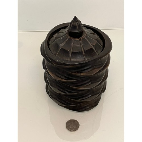 223 - A lidded treen pot with organic carving to the body, 19cm high.

This lot is available for in-house ... 