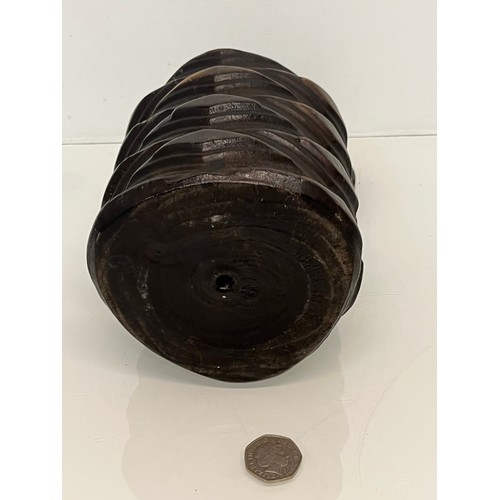 223 - A lidded treen pot with organic carving to the body, 19cm high.

This lot is available for in-house ... 