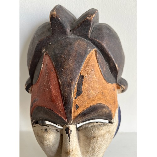 268 - Ethnic tribal art, a carved African mask with painted decoration.

This lot is available for in-hous... 