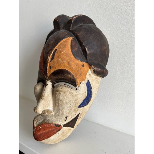 268 - Ethnic tribal art, a carved African mask with painted decoration.

This lot is available for in-hous... 