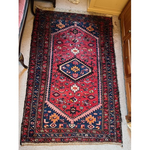 231 - Floor rug with a red ground.

This lot is available for in-house packing & shipping