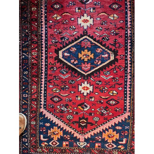 231 - Floor rug with a red ground.

This lot is available for in-house packing & shipping