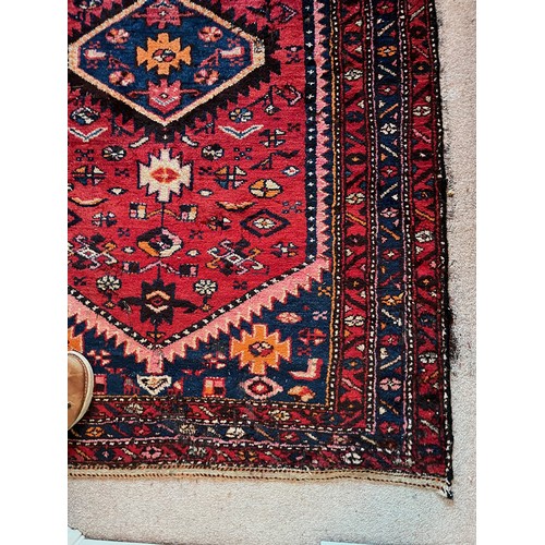 231 - Floor rug with a red ground.

This lot is available for in-house packing & shipping