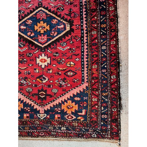 231 - Floor rug with a red ground.

This lot is available for in-house packing & shipping