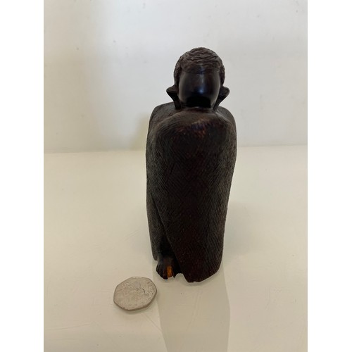 479 - Hand carved figure of an African tribesman huddled under a blanket, 15 cm high.


This lot is availa... 