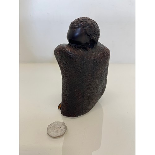 479 - Hand carved figure of an African tribesman huddled under a blanket, 15 cm high.


This lot is availa... 