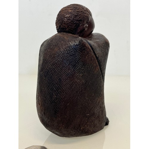 479 - Hand carved figure of an African tribesman huddled under a blanket, 15 cm high.


This lot is availa... 