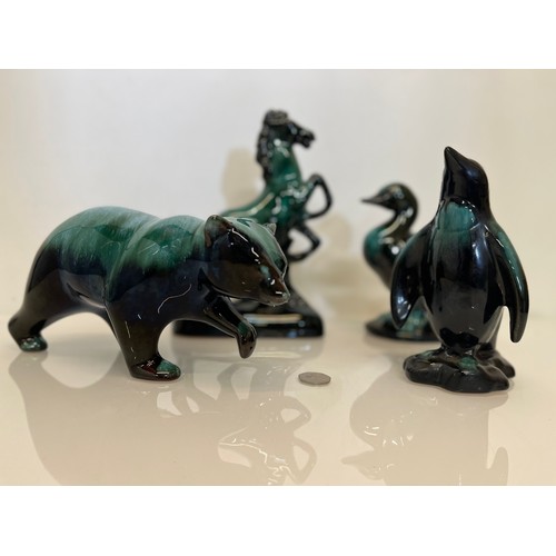 480 - Canadian Blue Mountain pottery figures, a bear , a penguin a duck and a rearing horse.

This lot is ... 