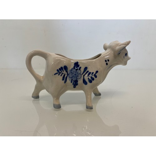 483 - A delft hand decorated Cow creamer and a mustard pot.

This lot is available for in-house packing & ... 