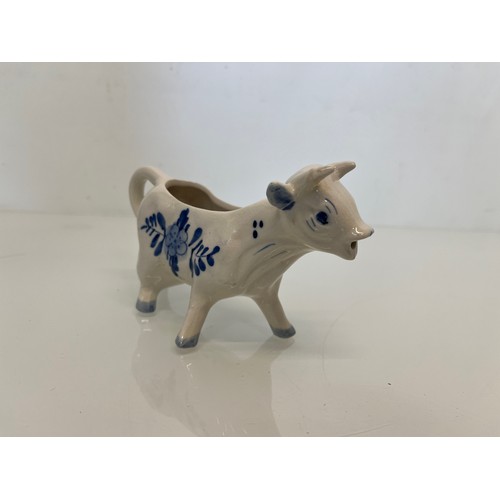 483 - A delft hand decorated Cow creamer and a mustard pot.

This lot is available for in-house packing & ... 