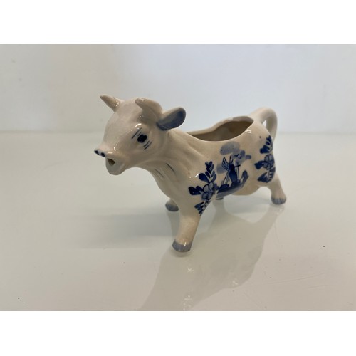 483 - A delft hand decorated Cow creamer and a mustard pot.

This lot is available for in-house packing & ... 