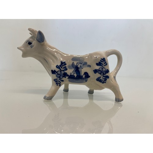 483 - A delft hand decorated Cow creamer and a mustard pot.

This lot is available for in-house packing & ... 