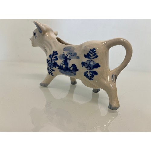 483 - A delft hand decorated Cow creamer and a mustard pot.

This lot is available for in-house packing & ... 