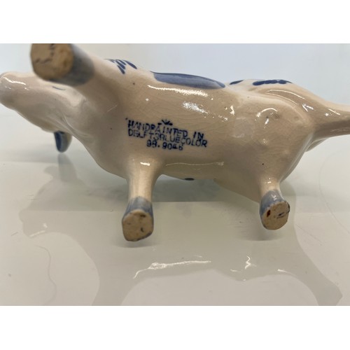 483 - A delft hand decorated Cow creamer and a mustard pot.

This lot is available for in-house packing & ... 