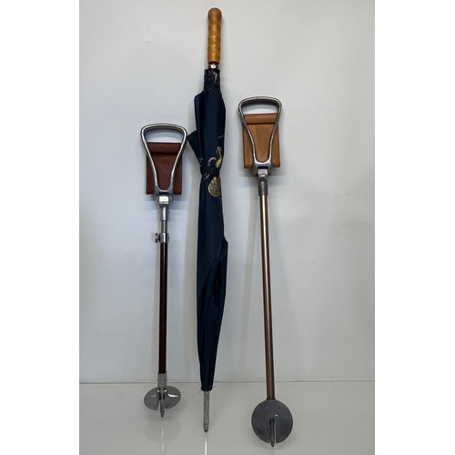 490 - Two shooting sticks, one is adjustable for height, and a large Brolly marked for Burghley.

This lot... 