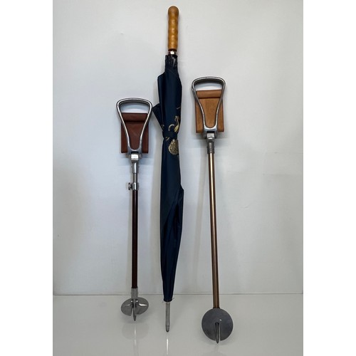 490 - Two shooting sticks, one is adjustable for height, and a large Brolly marked for Burghley.

This lot... 