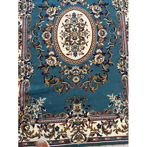 492 - Floor rug with a blue ground.

This lot is available for in-house packing & shipping