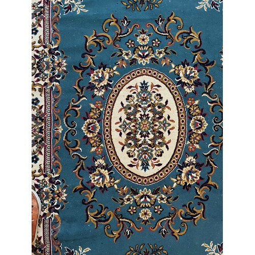 492 - Floor rug with a blue ground.

This lot is available for in-house packing & shipping