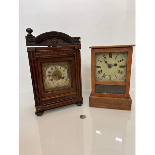 237 - Two early C20th wooden cased mantle clocks.

This lot is available for in-house shipping