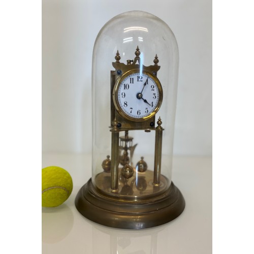233 - Brass mantle clock in a domed glass cover.

This lot is available for in-house shipping