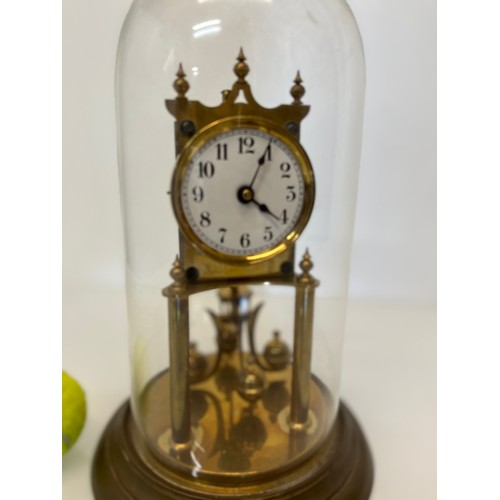 233 - Brass mantle clock in a domed glass cover.

This lot is available for in-house shipping