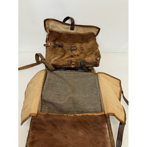 104 - Militaria, a pony skin ruck sac dated 45.

This lot is available for in-house shipping