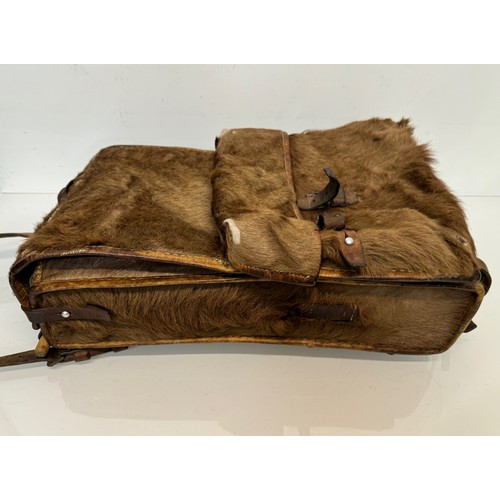 104 - Militaria, a pony skin ruck sac dated 45.

This lot is available for in-house shipping