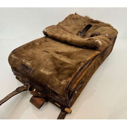 104 - Militaria, a pony skin ruck sac dated 45.

This lot is available for in-house shipping