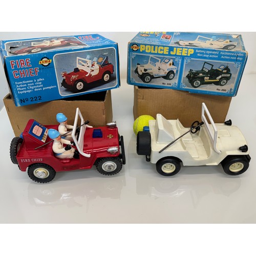 145 - Toys, two plastic Jeeps, a fire chief and a police themed model, both boxed and each is 23 cm long.
... 