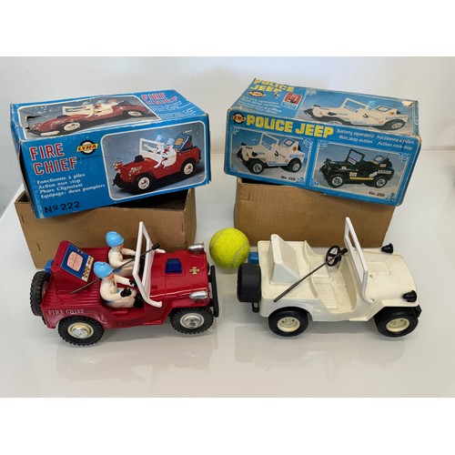 145 - Toys, two plastic Jeeps, a fire chief and a police themed model, both boxed and each is 23 cm long.
... 