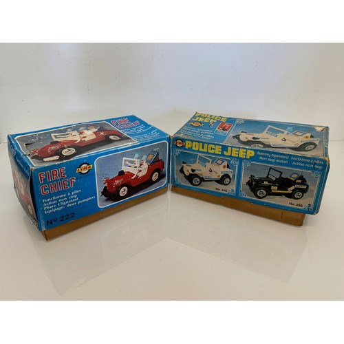 145 - Toys, two plastic Jeeps, a fire chief and a police themed model, both boxed and each is 23 cm long.
... 