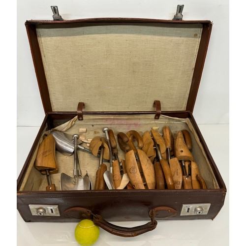 156 - Leather suitcase full with a collection of wooden and metal shoe lasts.

This lot is available for i... 