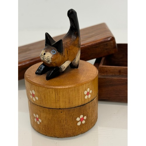 163 - Treen boxes, a circular box with a hand carved cat to the lid, 10 cm tall and another.

This lot is ... 