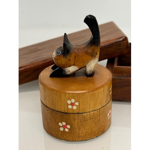 163 - Treen boxes, a circular box with a hand carved cat to the lid, 10 cm tall and another.

This lot is ... 