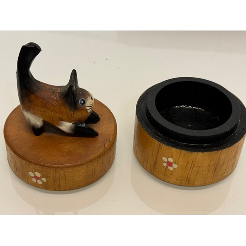 163 - Treen boxes, a circular box with a hand carved cat to the lid, 10 cm tall and another.

This lot is ... 