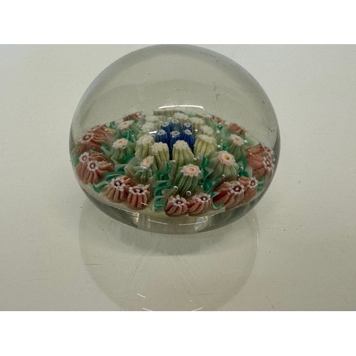 130 - Glass paper weight with domed internal decoration. 6 cm in dia.

This lot is available for in-house ... 