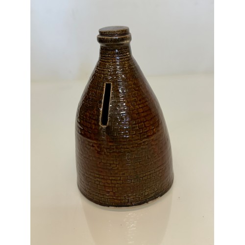 132 - Studio art pottery moneybox, a ceramic money box in the form of a brick kiln. 15 cm high.

This lot ... 