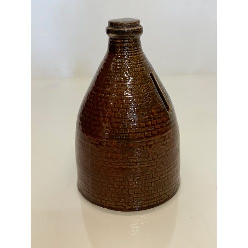 132 - Studio art pottery moneybox, a ceramic money box in the form of a brick kiln. 15 cm high.

This lot ... 