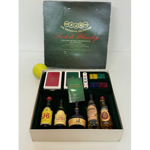 134 - Scotch Whisky, a whisky themed games compendium with five unopened bottles.

This lot is available f... 