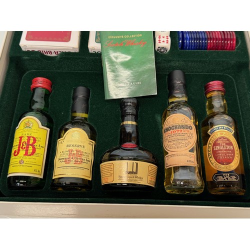 134 - Scotch Whisky, a whisky themed games compendium with five unopened bottles.

This lot is available f... 