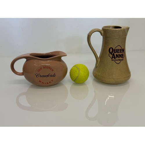 140 - Breweryana, advertising ceramics, two branded water jugs by Wade, Crawfords Whisky and Queen Anne Wh... 